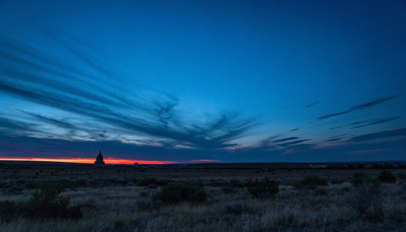 Cheyenne, Wyoming plains at dusk with the state capitol on the horizon