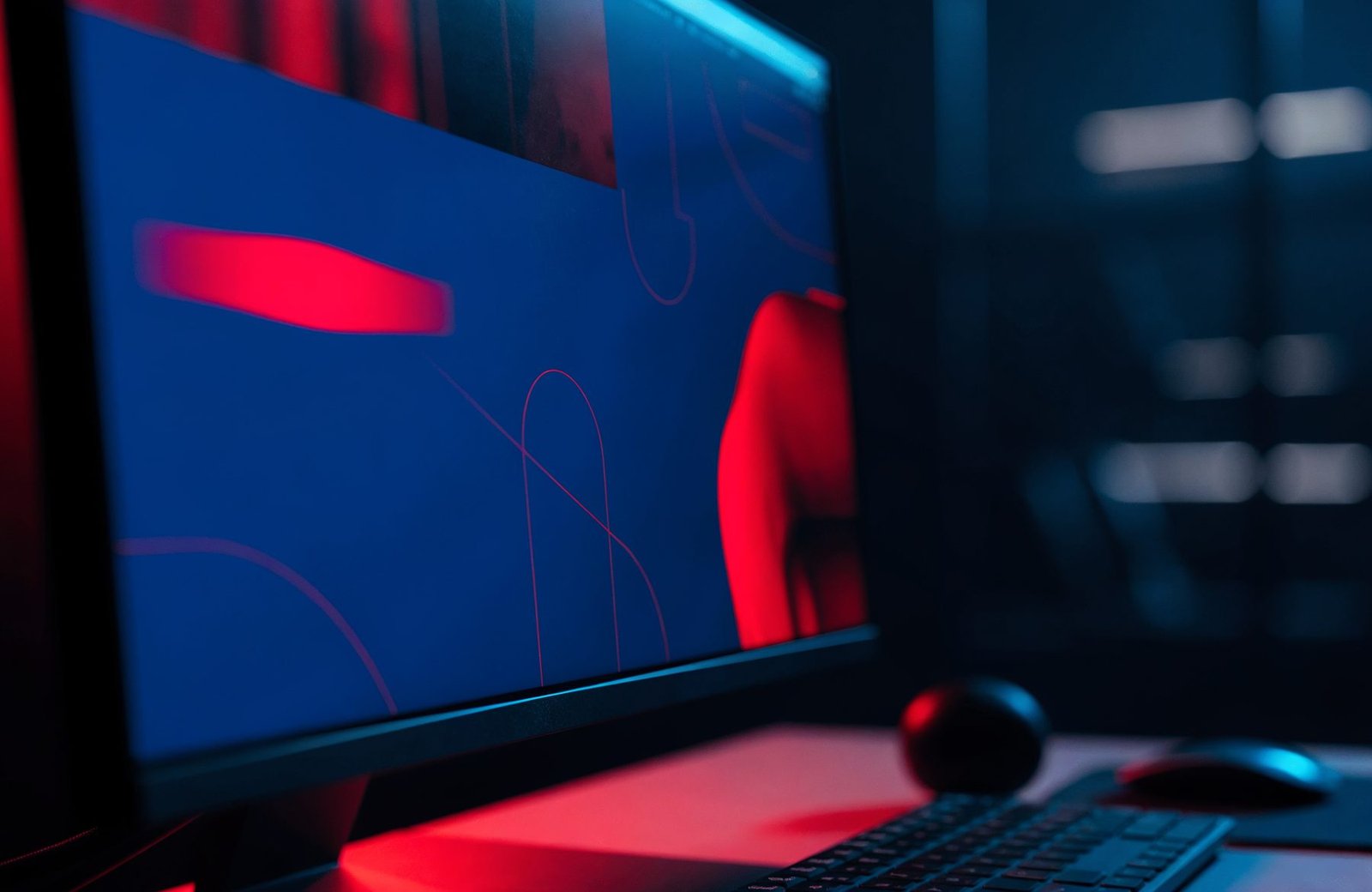 Website design on a widescreen monitor in a dark studio